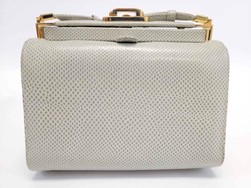 JUDITH LEIBER KARUNG LEATHER PURSE: JUDITH LEIBER KARUNG LEATHER PURSE: Pale green colored snakeskin purse with gold tone hardware and adjustable shoulder strap. Interior is lined in grey/lilac grosgrain fabric and includes a coin purse