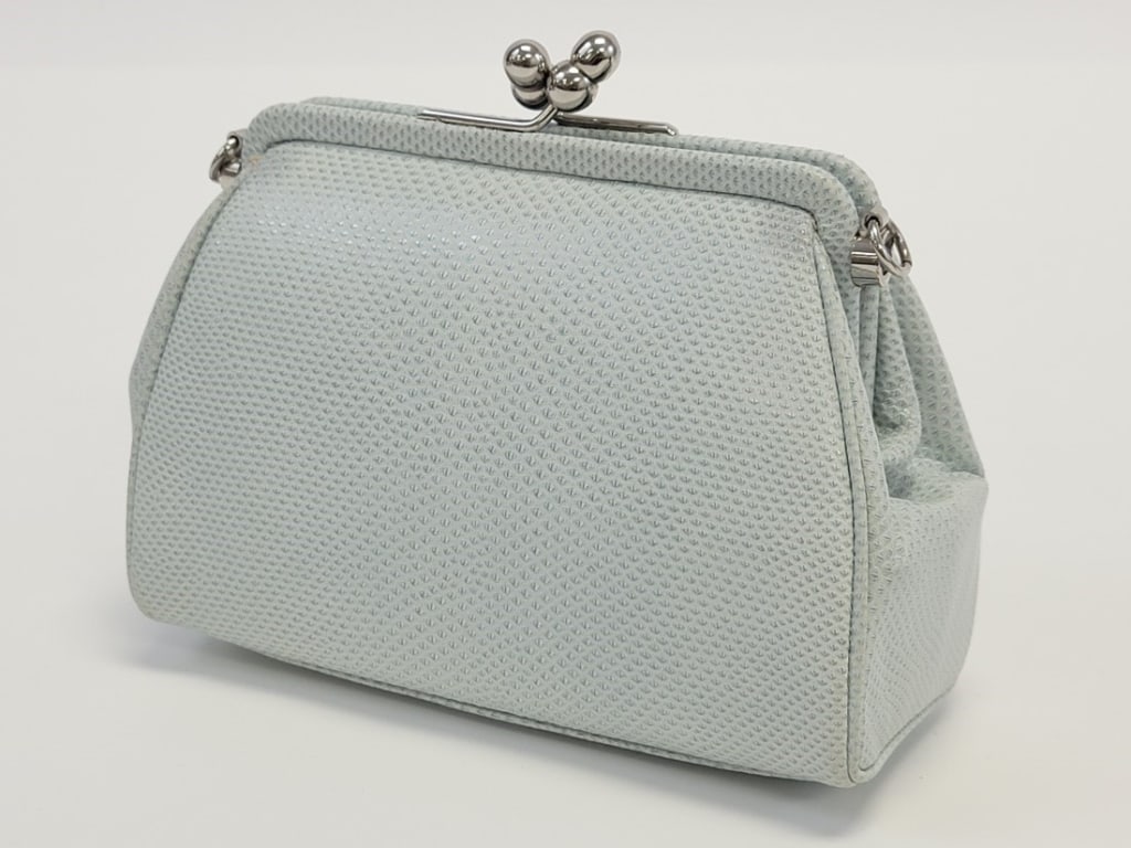 JUDITH LEIBER PALE BLUE KARUNG LEATHER CLUTCH: JUDITH LEIBER PALE BLUE KARUNG LEATHER CLUTCH: pale blue snakeskin clutch with silver tone hardware and kiss clasp closure. Pale blue satin fabric interior shows some minor fading/staining. Braided ro