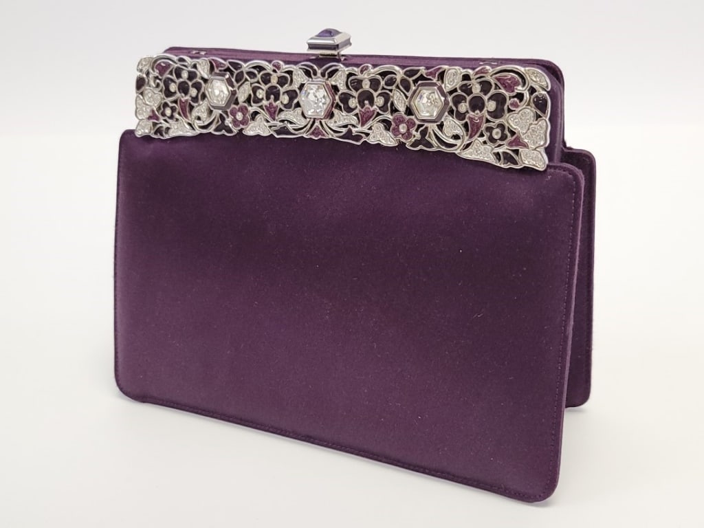 JUDITH LEIBER PURPLE SATIN EVENING CLUTCH: JUDITH LEIBER PURPLE SATIN EVENING CLUTCH: purple satin evening clutch with intricately designed Swarovski crystal and enamel top frame. Silver tone hardware and push clasp with central amethyst. Clut