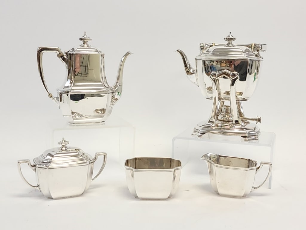 TIFFANY & CO "HAMPTON" STERLING SILVER TEA SERVICE: Tiffany & Co "Hampton" pattern sterling silver five piece tea service. Includes a hot water pot with stand and heater (measures 9.5" to top of finial), an 8.35" tall teapot, a 4.5" tall covered sugar 