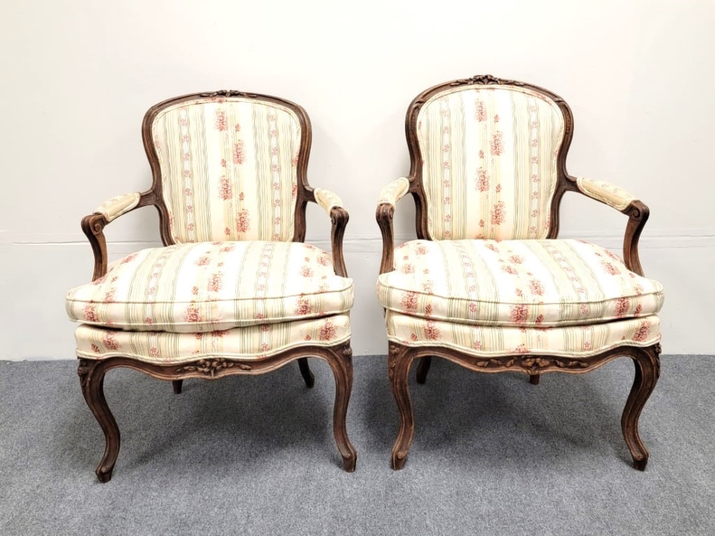 ANTIQUE ITALIAN LOUIS XV STYLE FAUTEUIL ARMCHAIRS: Pair of antique Italian 19th century hand carved Louis XV style fauteuil armchairs, each measuring 33.5" tall x 24.5" wide and 25" deep. Striped floral fabric upholstery. Condition: repair to the righ