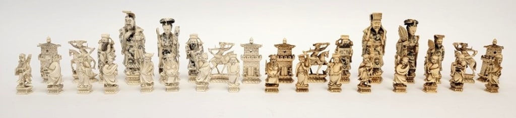 CHINESE CARVED BONE FIGURAL CHESS PIECES: Chinese carved bone figural chess pieces. Includes a variety of styles, all different, including each pawn. One side of tea stained, and the other white. Tallest piece is the King at 5", and the small