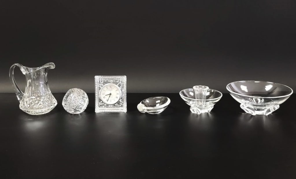 WATERFORD CRYSTAL & STEUBEN GLASS, 6 PCS: Lot of six pieces of Waterford crystal & Steuben glassware. Includes a 6.25" tall Waterford mini pitcher, a 3.25" tall Waterford spherical ashtray, a 4.75" tall Waterford desk clock, a 7.75" wide Steu