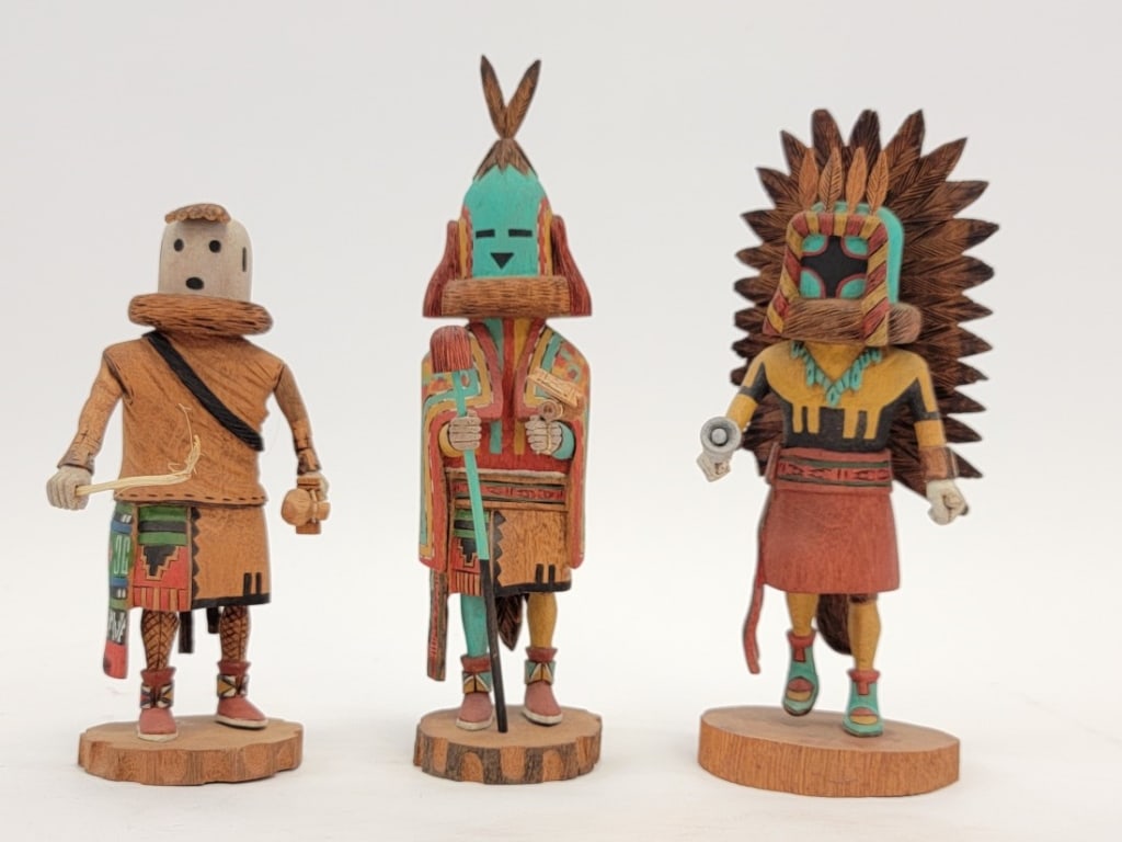 THREE TINO YOUVELLA HOPI CARVED WOOD KACHINA DOLLS: Lot of three Tino Youvella Hopi carved and painted wood Kachina dolls. Includes "Aholi Kachina" (9" tall to tip of feathers), "Eototo Kachina" (6.75" tall), and "Chasing Star Kachina" (8" tall). All p