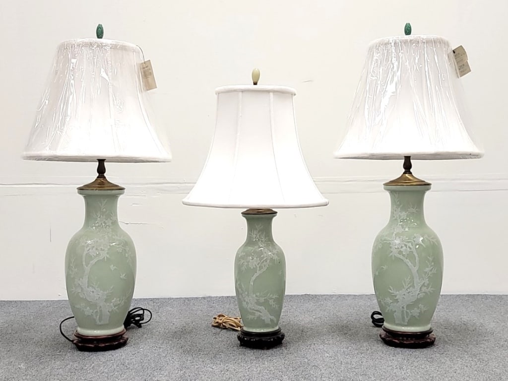 3 CHINOISERIE STYLE SAGE GREEN PORCELAIN LAMPS: Lot of three Chinoiserie style sage green porcelain table lamps with jade finials. Includes two measuring 32" to the tip of finial, or 15.5" to top of vase. The smaller lamp measures 27.5Z" tall to fi