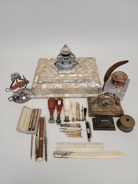 ASSORTED ANTIQUE DESK & WRITING ACCESSORIES: Huge lot of assorted antique desk accessories and writing instruments. Includes a large 13" wide mother of pearl clad ink stand / pen rest with glass inkwell, paper weight, various sterling pens and p