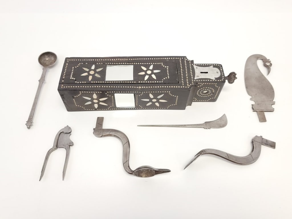 INDIAN WOODEN PAAN BETEL NUT BOX IRON TOOLS SAROTA: Antique Indian bone and mirror inlaid ebonized wood paan or betel nut tool / preparation box, as known as a Sarota set. Box slides open to reveal six hand wrought iron attachments and tools / blades.