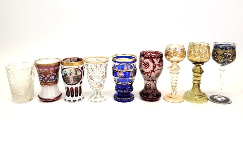 COLLECTION BOHEMIAN CASED GLASS TUMBLERS ETC: Collection of antique Bohemian cased and cut glass tumblers and stems. Includes six tumblers, ranging from 6.5" tall down to 4.75" tall. Variety of styles, one is uncolored but elaborately engraved. T