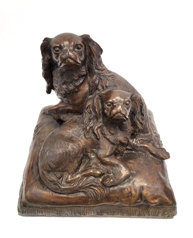 CHARLES VALTON BRONZE SCULPTURE OF SPANIELS: Charles Valton bronze sculpture of two Cavalier King Charles Spaniels on a dog bed. Measures a total of 17.5" tall x 18.5" wide and 16.5" deep. Signed at the front right "C. Valton". Condition is good