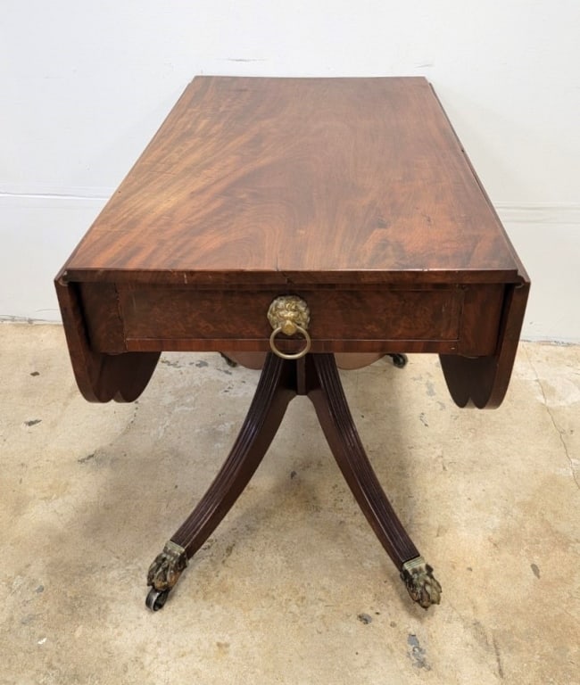 REGENCY PERIOD DOUBLE DROP LEAF PEDESTAL TABLE: Antique early 19th century Regency period flame mahogany double drop leaf table with a Duncan Phyfe style pedestal base. Measures a total of 28" tall x 36" long and 21.75" wide (with leaves down), and
