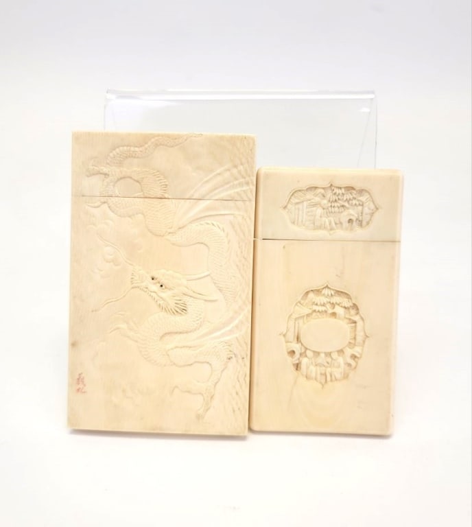 TWO ANTIQUE CHINESE CARVED BONE CARD CASES: Lot of two antique Chinese carved bone card cases. The first one depicting a dragon (signed in lower left corner) and measures 3.73" tall x 2.26" wide and 5/16" thick. The second one is carved with mu