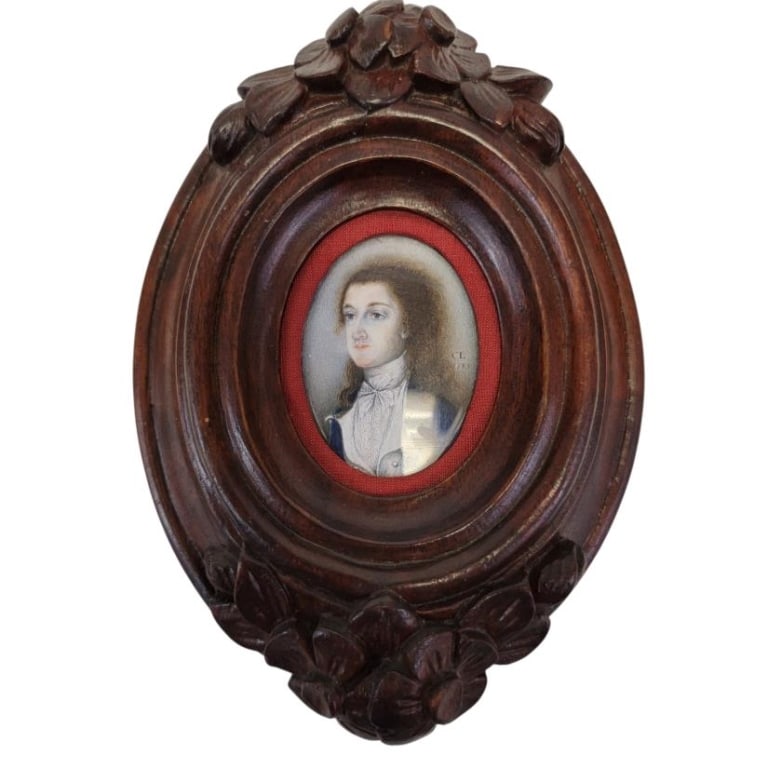 ANTIQUE 18TH CENTURY MINIATURE PORTRAIT PAINTING: Antique 18th century miniature portrait painting on bone depicting a gentleman in period attire. Initialed "CL" and dated "1783" right side. Held behind convex glass in a 19th century carved mahogany