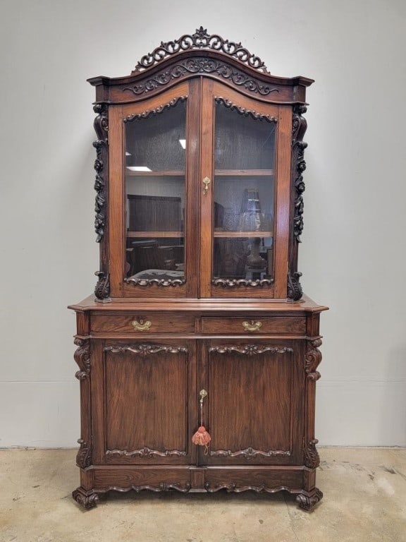 VICTORIAN ROCOCO REVIVAL STEP BACK CUPBOARD HUTCH: Antique Victorian Rococo revival period carved mahogany step-back cupboard / bookcase. Elaborate scrolled and floral carvings throughout. Measures a total of 86.25" tall x 47" wide and 20.5" deep.