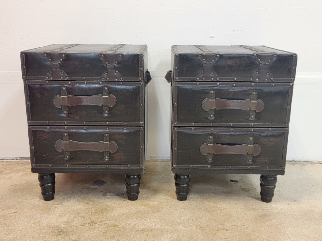 PR CAMPAIGN STYLE LEATHER LINED SIDE TABLES CHESTS: Pair campaign style leather lined side tables or chests. Each one with two drawers. Measuring a total of 21.5" tall x 17" wide x 16" deep. Condition: minor signs of wear and use to leather finish,