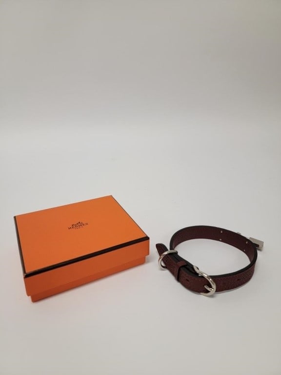 HERMES "KELLY" ROUGE LEATHER DOG COLLAR: Hermes "Kelly" rouge Taurillon Clemence leather dog collar. Unbuckled and laid out, it measures 13" long. Includes Hermes orange box. Condition: box may show minor signs of normal handling and age,