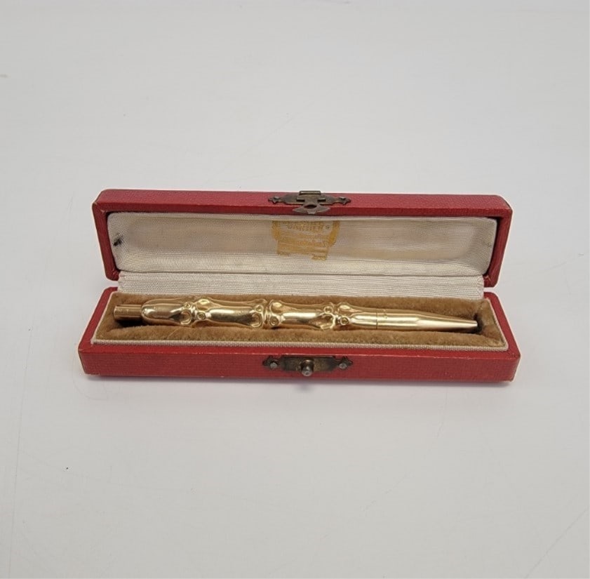 CARTIER 14K GOLD BAMBOO FORM PEN: Cartier 14k gold Bamboo form pen in original red velvet lined box. Pen is marked 14k L, but is NOT marked Cartier. Pen measures 4-1/8" long and approx. 7/16" diameter. Box measures 4.75" long x 1" tal
