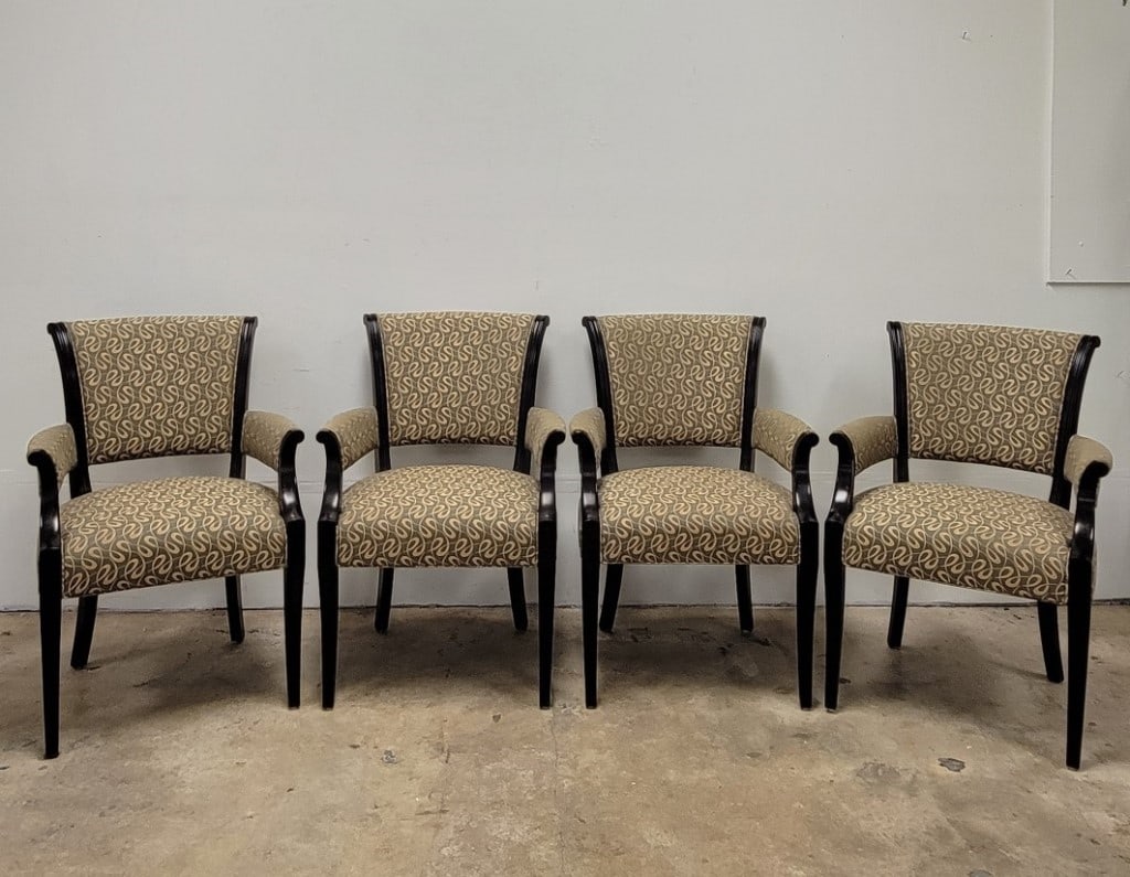 FOUR BAKER FURNITURE DINING ARMCHAIRS: Set of four upholstered dining armchairs by Baker. Repeating pattern upholstery and dark ebony finish wood frame. Each chair tagged on base. Condition: finishes may show minor signs of normal handling