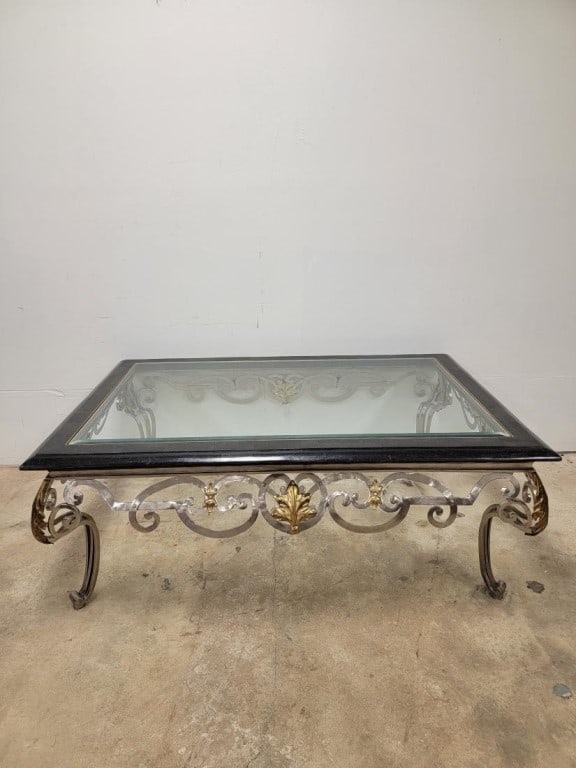 CONTEMPORARY TWO TONE METAL & GLASS COFFEE TABLE: Contemporary two tone metal coffee table with an inset beveled glass top and tessellated marble border. Base features both silver tone and gold tone accents. Measures 22" tall x 62" long and 42" wide.