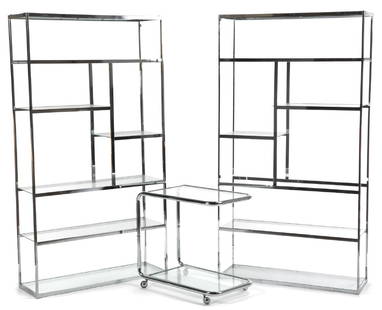 CHROME AND GLASS FURNISHINGS: Two modern shelving units, together with a similar glass and chrome bar cart. Shelving, 78 by 41 1/2 by 14 1/4 inches Categories: Tommy Hilfiger