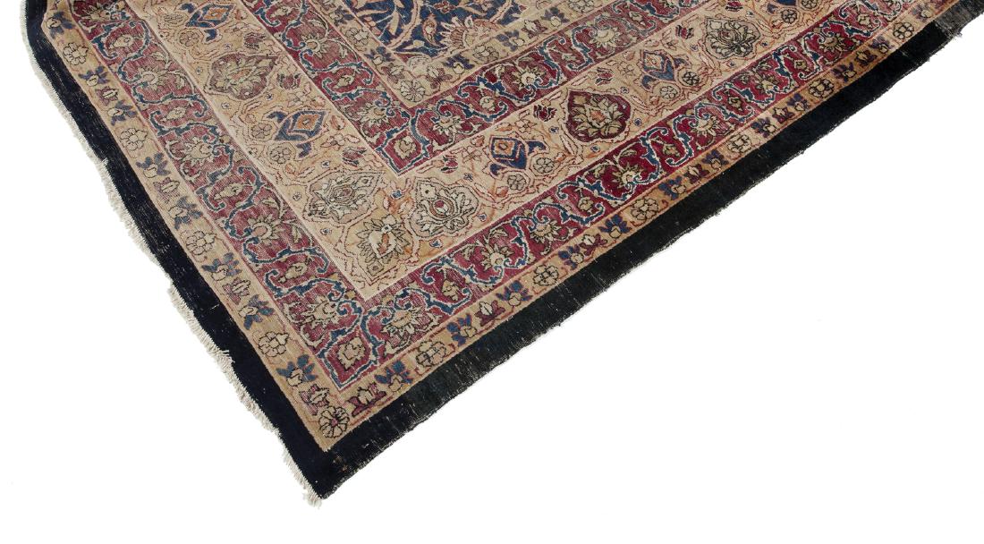 ORIENTAL RUG IN BEIGE, MAGENTA AND NAVY: A flat weave kilim with allover floral pattern in tan and magenta on a blue field with a black selvage edge. 178 by 118 inches Categories: Tommy Hilfiger