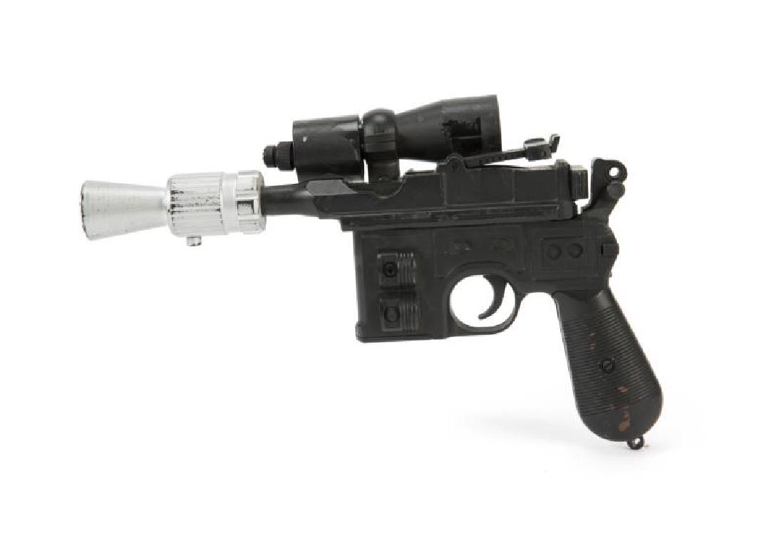 RETURN OF THE JEDI HAN SOLO MOVIE PROP DL-44 BLASTER: An original production used ""BlasTech DL-44"" blaster prop used by Harrison Ford as Han Solo in Return of the Jedi (Lucasfilm, 1983). The prop is custom made, built on a metal working non-firing mode