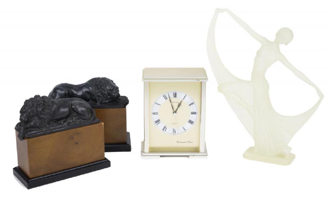 HUGH HEFNER DECORATIVE OBJECTS: A group of decorative objects including an Art Deco style plastic figure of a lady, a pair of cast spelter lion bookends, and a Seiko mantel clock. Tallest, 13 3/4 inches PROVENANCE From the Collectio