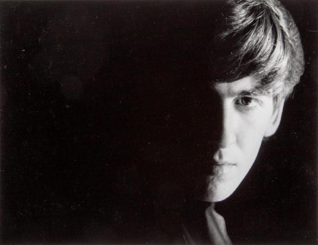 GEORGE HARRISON PHOTOGRAPH BY ASTRID KIRCHHERR: A black and white photograph of George Harrison by photographer Astrid Kirchherr, signed on verso in pencil by the photographer. £250-400 $300-500 7 by 9 1/2 inches The Beatles