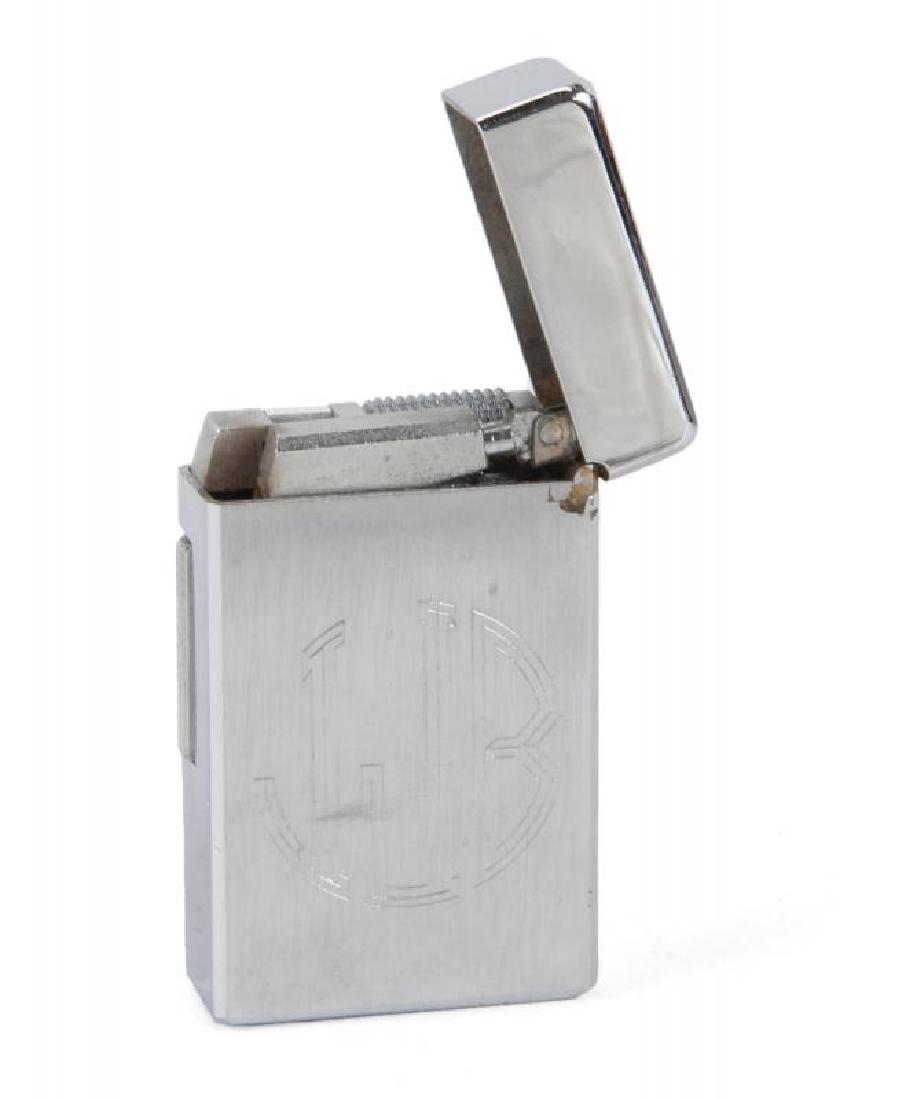 JAMES BROWN OWNED ENGRAVED PLAYBOY LIGHTER: A silver-toned Playboy lighter with James Brown's initials "JJB" engraved on one side and "To James Merry Christmas 1970" on the other. The lighter is stamped "Playboy 110" beneath and has a black Pla