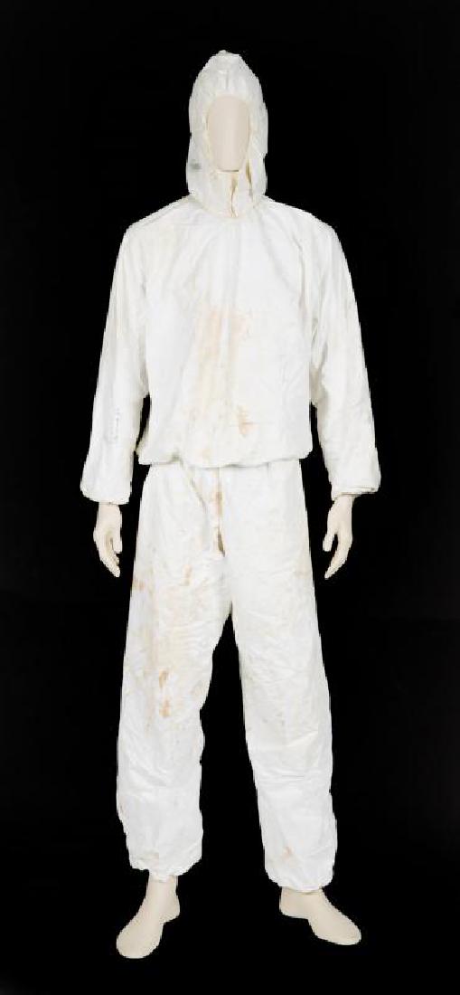 QUEEN SIGNED "RADIO GA GA" VIDEO ENSEMBLE: A heavily stained three-piece white paper ensemble worn by an extra in Queen's 1984 "Radio Ga Ga" music video. The long-sleeve blouse is signed on the left arm by Freddie Mercury and Brian May and on