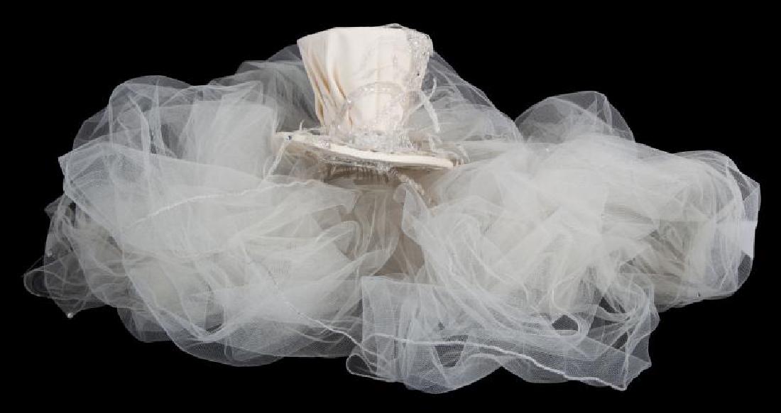 SLASH PERLA HUDSON WEDDING VEIL: A beaded and sequin top hat wedding veil with crystals on the hat and on the veil, worn by Perla Hudson at her wedding to Slash. Hat, height, 4 1/2 inches PROVENANCE From the Collection of Slash and P