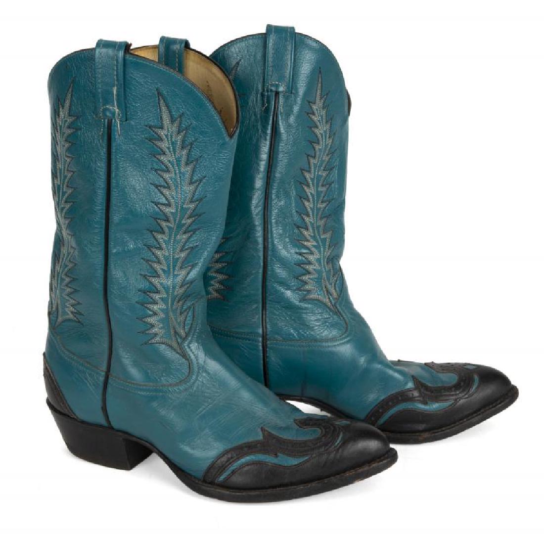 BURT REYNOLDS TURQUOISE COWBOY BOOTS: A pair of boots in turquoise leather with black overlay and piping. Made by Tony Lama, size 10 1/2 EE.; PROVENANCE From the Estate of Burt Reynolds; Burt Reynolds