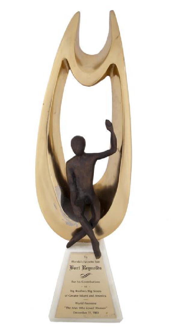 BURT REYNOLDS AWARD: A piece presented to the actor at the "World Premiere / The Man Who Loved Women" in 1983 by Big Brothers & Big Sisters of Greater Miami and America for "Contributions;" substantial and weighty bronze
