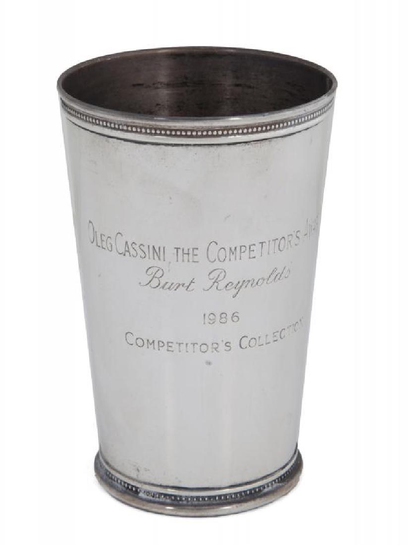 BURT REYNOLDS AWARD: A piece in the form of a cup, presented to the actor in 1986 by the Oleg Cassini Competitor's Collection for winning the "Competitor's Award," bottom stamped "Tiffany & Co / Sterling / 895L."; PROVENA