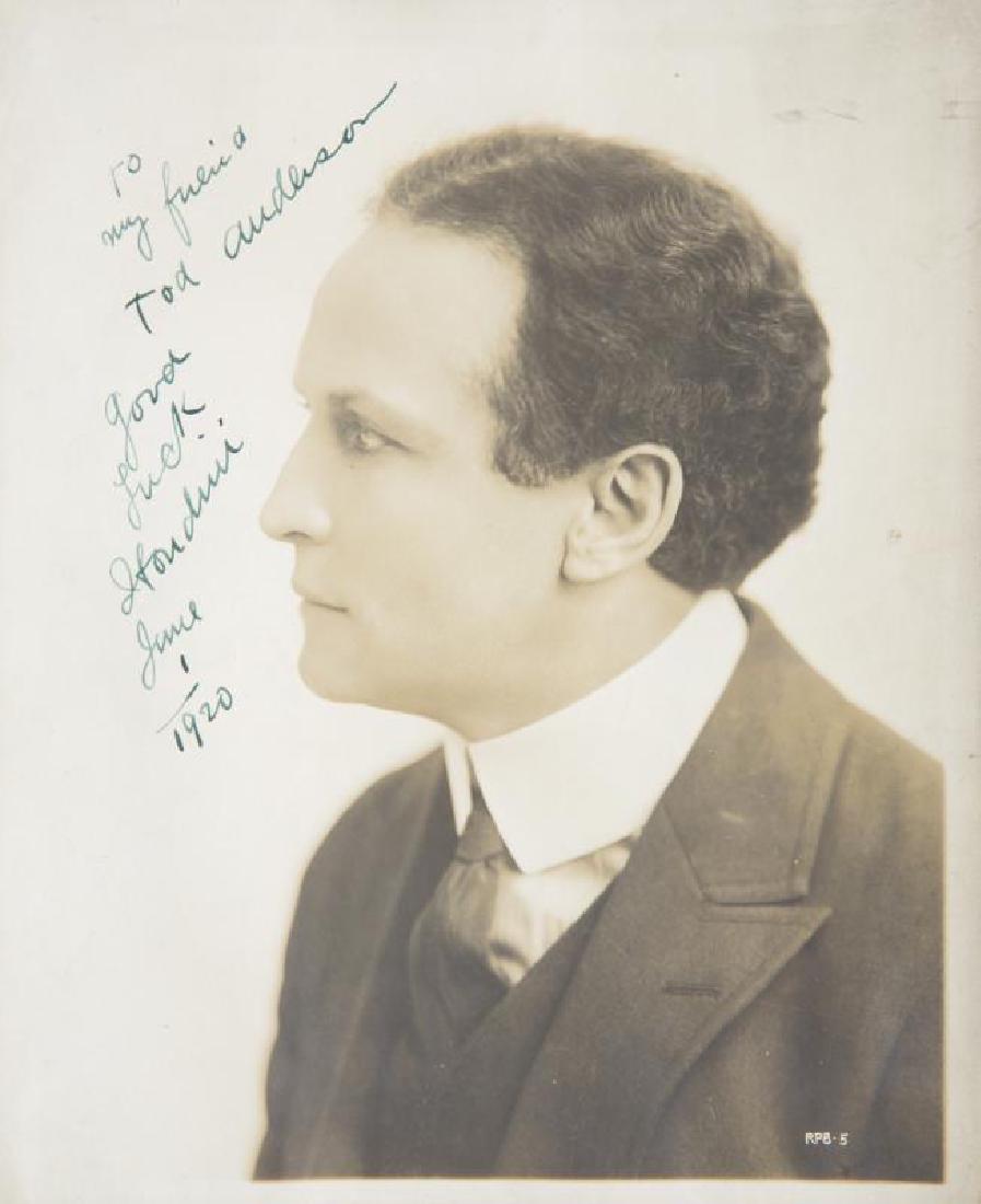 HARRY HOUDINI SIGNED AND INSCRIBED PHOTOGRAPH: A sepia-tone photograph of Harry Houdini taken at The London Palladium, signed and inscribed in blue ink "to my friend Tod Anderson good luck Houdini June 1 1920." 10 by 8 inches Harry Houdini