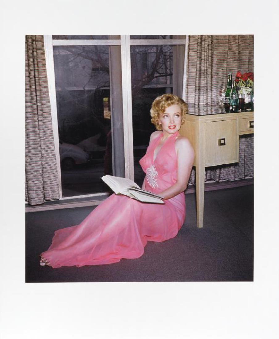 MARILYN MONROE HAROLD LLOYD PHOTOGRAPH: A large-format color photograph taken by Harold Lloyd of Marilyn Monroe reading a book in a pink negligee. Numbered 21/250 on the verso and bearing the Harold Lloyd Trust seal to the lower right corne