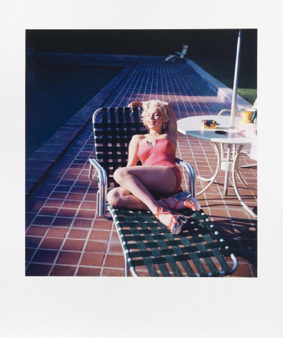MARILYN MONROE HAROLD LLOYD PHOTOGRAPH: A large-format color photograph taken by Harold Lloyd of Marilyn Monroe lounging poolside in a pink coral swimsuit with rhinestone accents. Numbered 21/250 on the verso and bearing the Harold Lloyd Tr