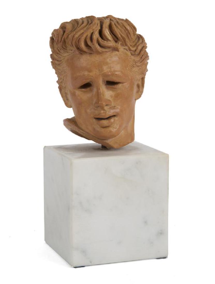 BURT REYNOLDS JAMES DEAN MINIATURE SCULPTURE: A small piece made of amber-colored resin depicting the young actor's head, text on base reads "James Dean," affixed to a white marble block, sticker on bottom of block reads "James Dean / Kendall 195