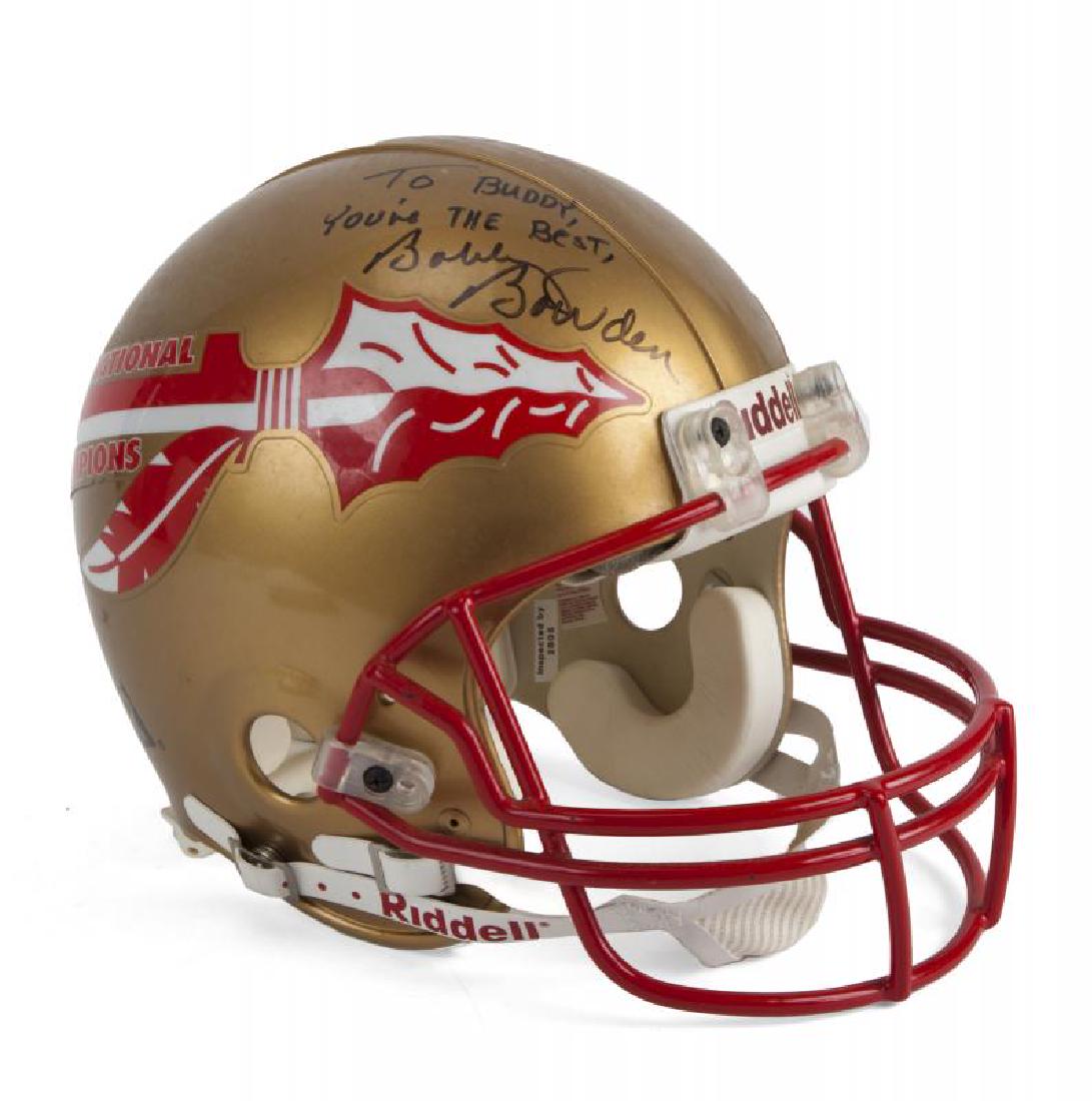 FSU FOOTBALL HELMET INSCRIBED TO BURT REYNOLDS: A 1993 National Champions commemorative Riddell VSR-2 helmet. Inscribed in black marker by the 1993 FSU football head coach and quarterback with "To BUDDY, You're THE Best, Bobby Bowden" and "Go Noles