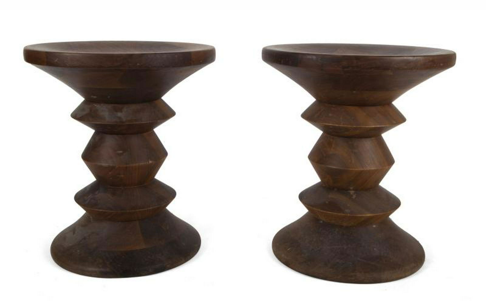 B.B. KING PAIR OF TIME LIFE STOOLS: A pair of mid-century modern walnut stools, shape "C," designed by Charles and Ray Eames and manufactured by Herman Miller. Unmarked. Height, 15 inches; Diameter, 13 inches PROVENANCE From the Estate