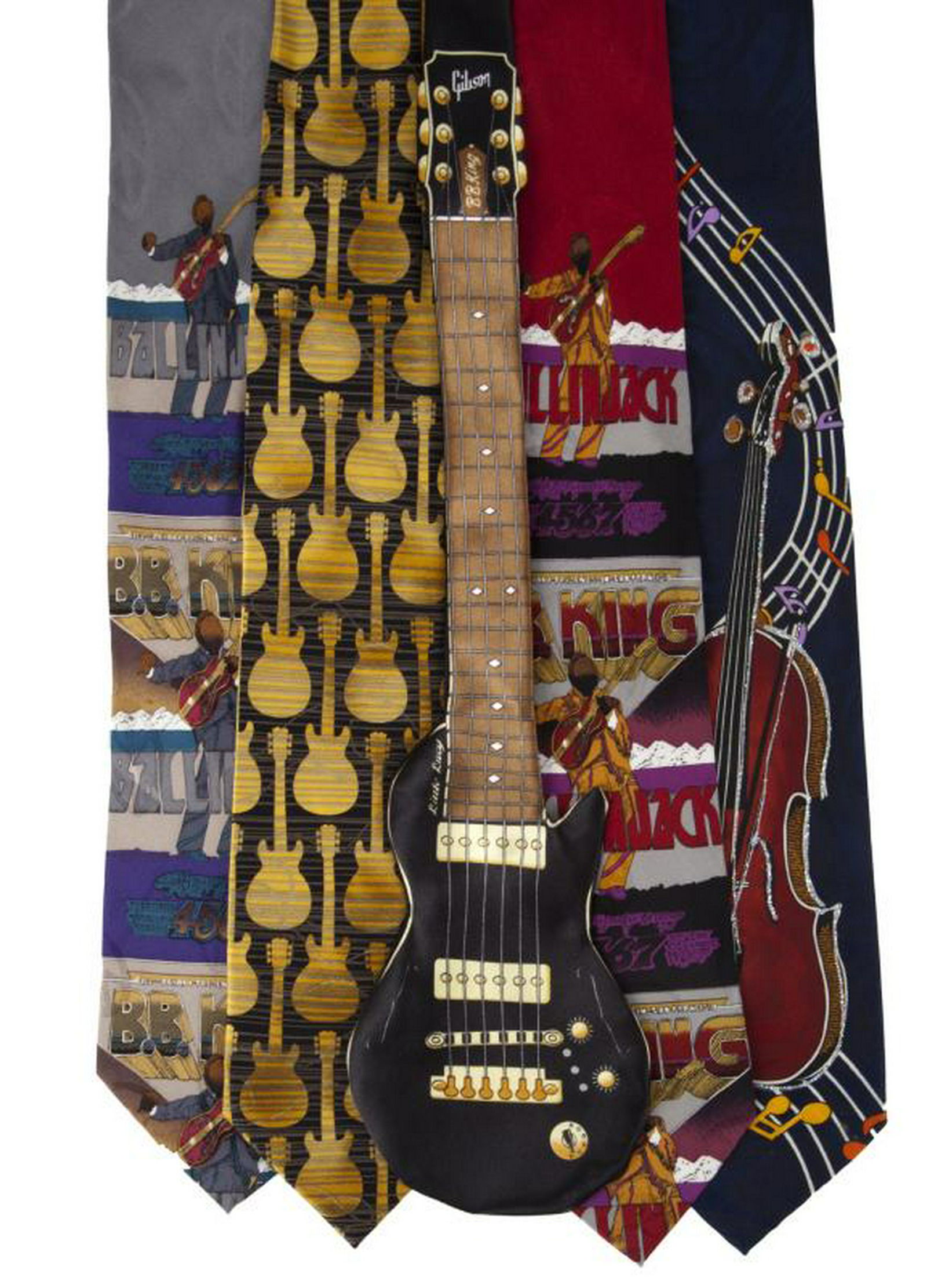 B.B. KING NOVELTY TIES: A group of five ties: two by The Fillmore Poster Ties titled "B.B. King" and designed by Bill Graham, both numbered 269; one in the shape of a Gibson B.B. King guitar by Why-Knot; a gold and black gui