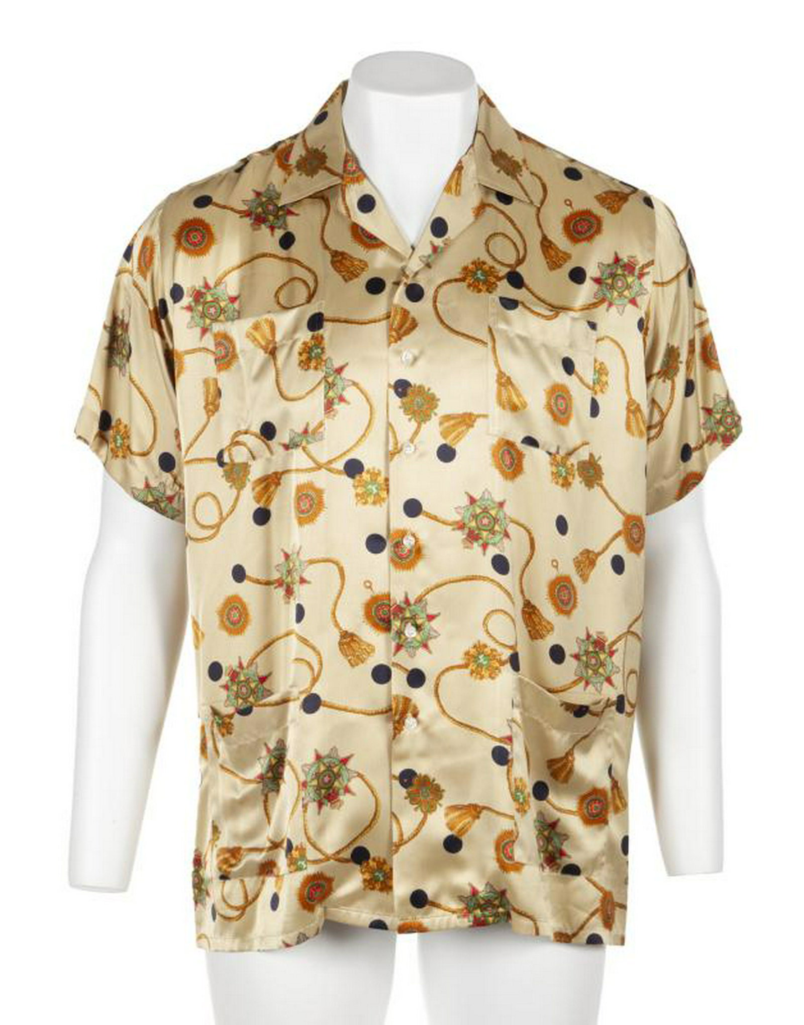 B.B. KING STAGE WORN SHIRT: A short-sleeve yellow silk shirt with tassel and medallion pattern worn by B.B. King while performing at the 1999 B.B. King Blues Festival at Universal Amphitheatre in Universal City, California. The 
