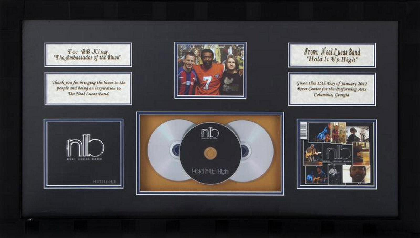 B.B. KING NEAL LUCAS BAND CD AWARD: A plaque presented to B.B. King, "The Ambassador of the Blues," from the Neal Lucas Band, featuring their CD Hold It Up High, dated 2012. 18 by 30 3/4 inches, framed PROVENANCE From the Estate of B.B.