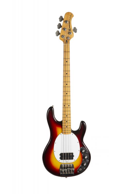 WALTER BECKER 1976 MUSIC MAN STINGRAY BASS: A 1976 Music Man Stingray bass that was a favorite of Walter Becker during the 1990s. The body is finished in three-color sunburst and fitted with a single humbucking pickup. The neck plate is impress