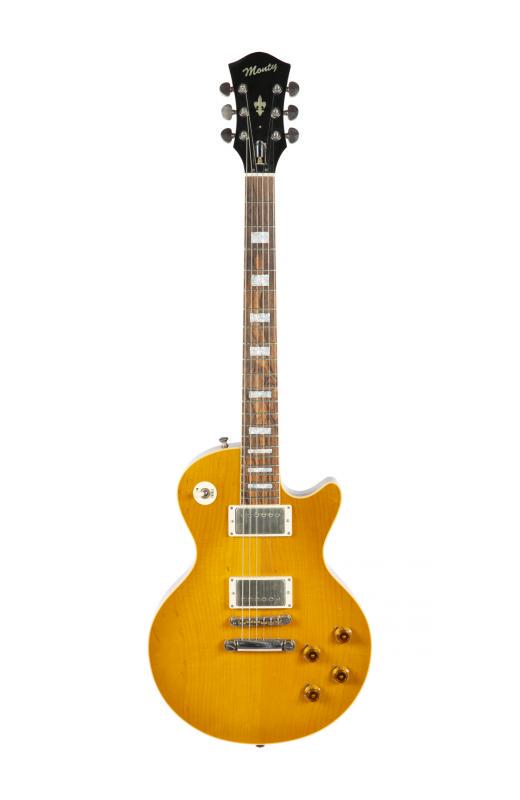 WALTER BECKER MONTY BLUESMASTER GUITAR: A Monty Bluesmaster electric guitar with a natural finish birch top and cherry stained chambered mahogany body and maple neck. Serial number 0082 stamped to headstock. Accompanied by a hard shell case