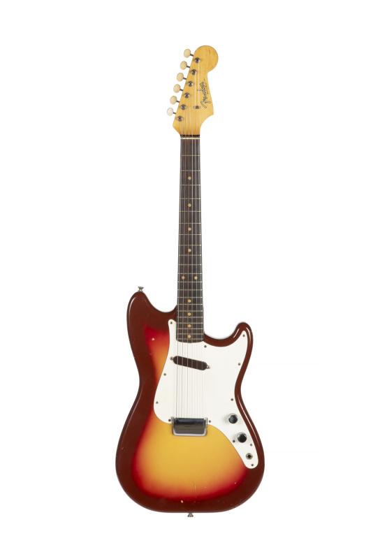 WALTER BECKER 1964 FENDER MUSICMASTER: A 1964 Fender Musicmaster electric guitar with Shaded Sunburst finish and one single coil pickup. The neck plate is impressed with the serial number 98556. Accompanied by a hard shell case PROVENANCE 