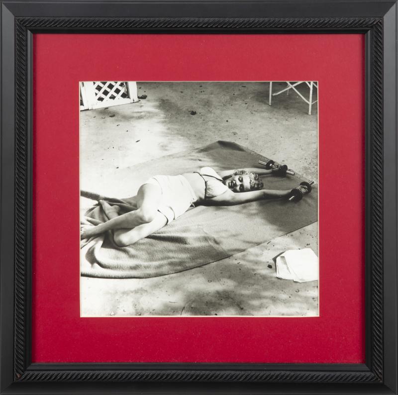 MARILYN MONROE BLACK AND WHITE PHOTOGRAPHS ANNOTATED BY: A set of two, both original 1952-era prints with a glossy finish, depicting the star working out with hand weights at the Hotel Bel Air in Los Angeles, photographer's red ink credit stamp appears on v