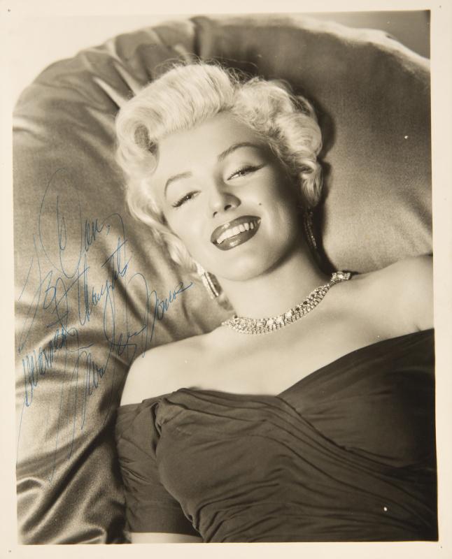 MARILYN MONROE SIGNED BLACK AND WHITE HEADSHOT: An original print with a matte finish, depicting one of the most iconic images of the star, signed in blue ballpoint ink on the left side "To Dan, / Warmest thoughts / Marilyn Monroe." 10 by 8 inches 