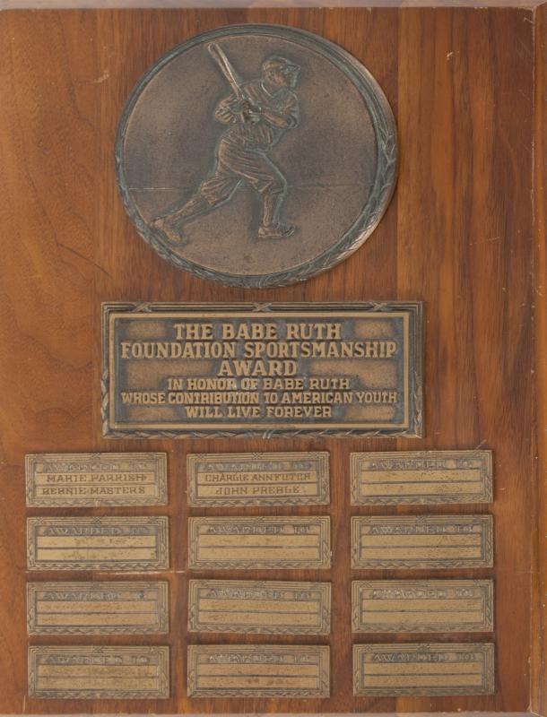 BABE RUTH SPORTSMANSHIP AWARD: A Babe Ruth Foundation Sportsmanship Award plaque circa 1950. The plaque has an applied brass medallion of Ruth batting with title and nameplates below, marked "Balfour" on back. 14 by 10 inches Baseb