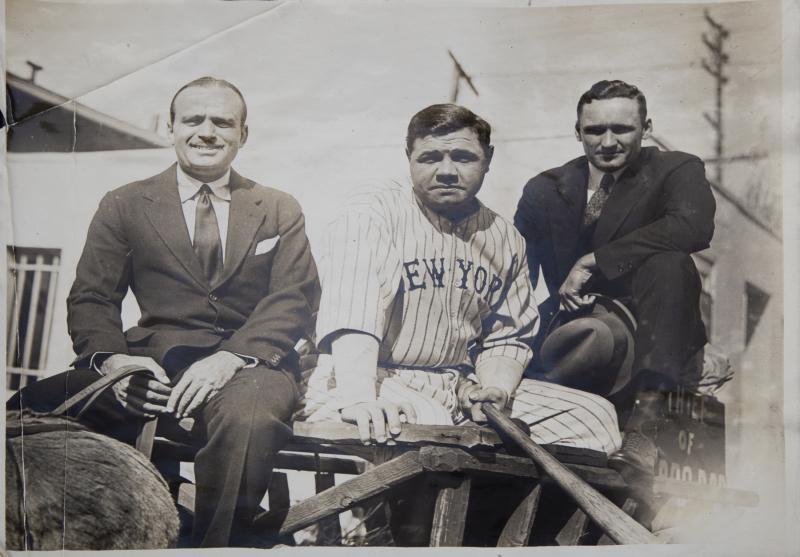 BABE RUTH, WALTER JOHNSON, AND DOUG FAIRBANKS: An original black and white photograph of Babe Ruth, Douglas Fairbanks, and Walter Johnson taking part in a pickup game on October 1924. Stamped and inscribed on verso. 8 by 10 inches Baseball