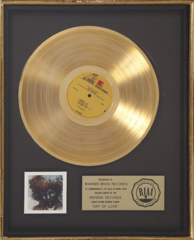 JIMI HENDRIX THE CRY OF LOVE "GOLD" RECORD AWARD •: A "gold" record award presented to Warner Bros. for the Jimi Hendrix album The Cry of Love, the album Hendrix was working on at the time of his death and the first posthumous Hendrix record release. F